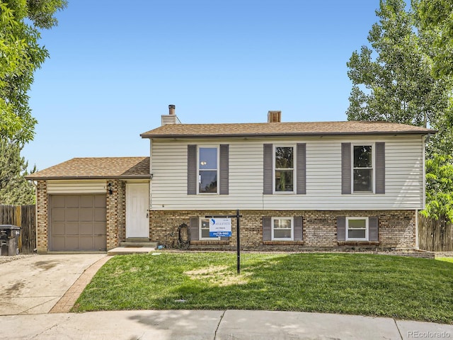 11062 Hudson Ct, Thornton, CO 80233 - split level home with a garage, driveway, brick siding, and a chimney