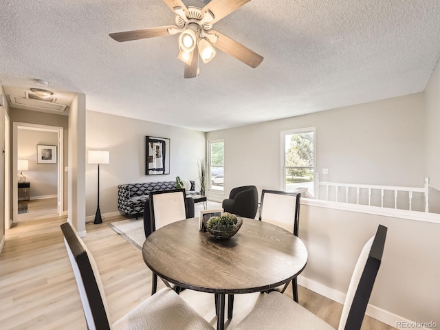 11062 Hudson Ct, Thornton, CO 80233 - dining room with a textured ceiling, light wood-style flooring, baseboards, and a ceiling fan