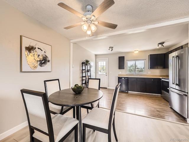 11062 Hudson Ct, Thornton, CO 80233 - dining room with a textured ceiling, a ceiling fan, light wood finished floors, and baseboards