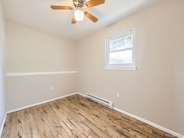 11062 Hudson Ct, Thornton, CO 80233 - spare room featuring a baseboard heating unit, wood finished floors, baseboards, and a ceiling fan