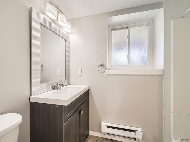 11062 Hudson Ct, Thornton, CO 80233 - bathroom featuring baseboard heating, vanity, and toilet