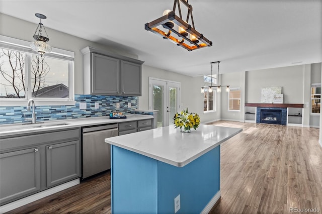 8414 Bed Straw St, Parker, CO 80134 - kitchen with dishwasher, a sink, gray cabinets, and light countertops