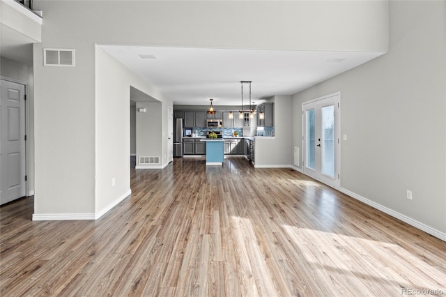 8414 Bed Straw St, Parker, CO 80134 - unfurnished living room with wood finished floors, baseboards, and a chandelier