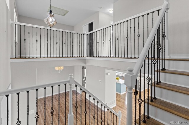 8414 Bed Straw St, Parker, CO 80134 - stairs with wood finished floors and a chandelier
