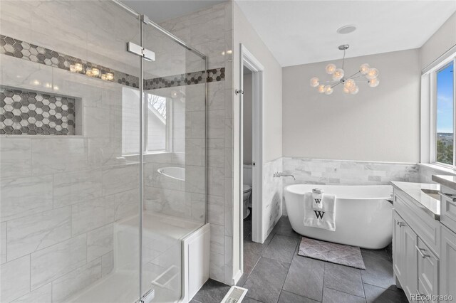8414 Bed Straw St, Parker, CO 80134 - full bath with a shower stall, a freestanding bath, vanity, a chandelier, and tile walls