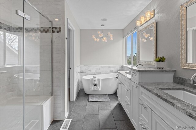 8414 Bed Straw St, Parker, CO 80134 - full bath with plenty of natural light, vanity, a stall shower, a soaking tub, and a wainscoted wall