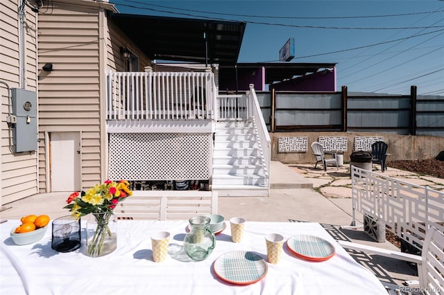 view of patio with outdoor dining space and stairway