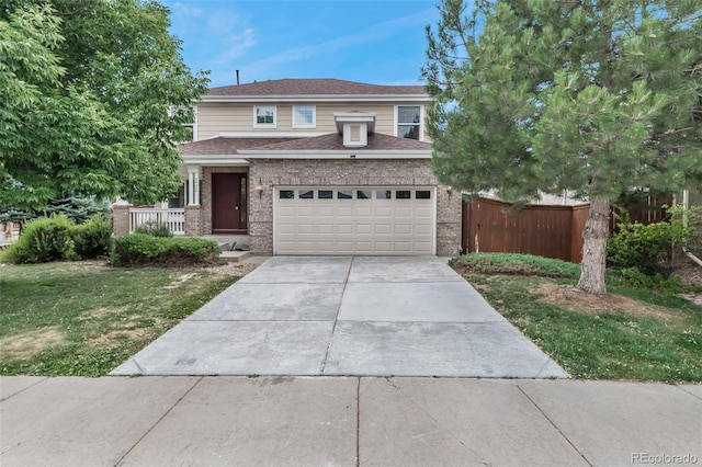 2430 S Jebel Way, Aurora, CO 80013 - view of front facade featuring brick siding, driveway, a garage, covered porch, and roof with shingles