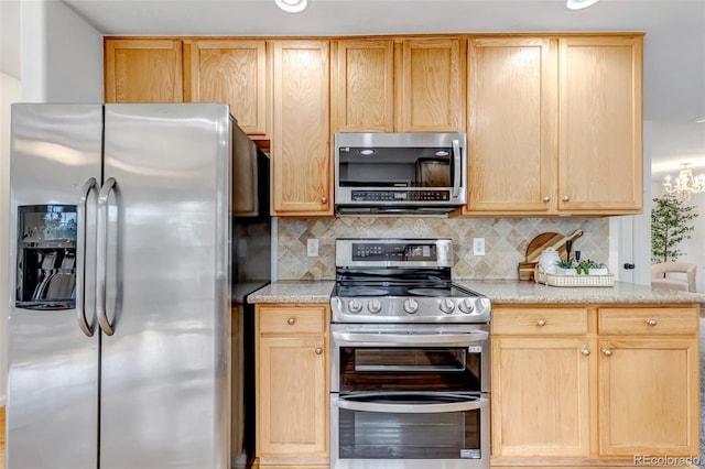 2430 S Jebel Way, Aurora, CO 80013 - kitchen featuring appliances with stainless steel finishes, backsplash, and light brown cabinets