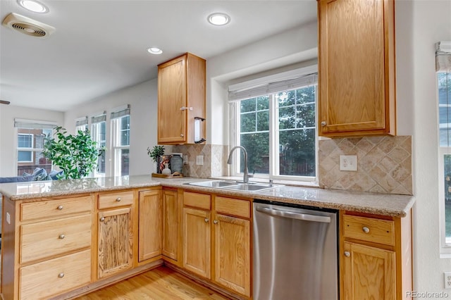 2430 S Jebel Way, Aurora, CO 80013 - kitchen featuring dishwasher, a peninsula, plenty of natural light, light wood-style flooring, and recessed lighting