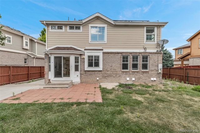 2430 S Jebel Way, Aurora, CO 80013 - back of house featuring a patio area, a fenced backyard, and brick siding
