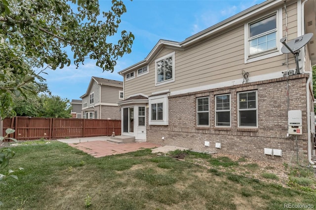 2430 S Jebel Way, Aurora, CO 80013 - rear view of house featuring brick siding, a patio, entry steps, and crawl space