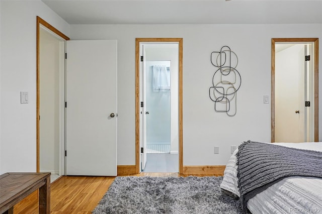 3053 Mcintosh Dr, Longmont, CO 80503 - bedroom featuring light wood finished floors and ensuite bathroom
