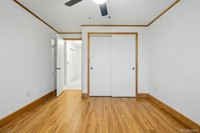 3053 Mcintosh Dr, Longmont, CO 80503 - unfurnished bedroom featuring crown molding, light wood finished floors, a closet, and a ceiling fan