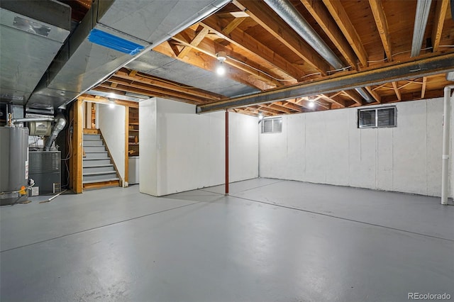 3053 Mcintosh Dr, Longmont, CO 80503 - unfinished below grade area featuring gas water heater, stairs, and heating unit