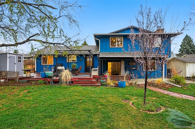 3053 Mcintosh Dr, Longmont, CO 80503 - back of house featuring a lawn, a chimney, board and batten siding, a shingled roof, and a porch