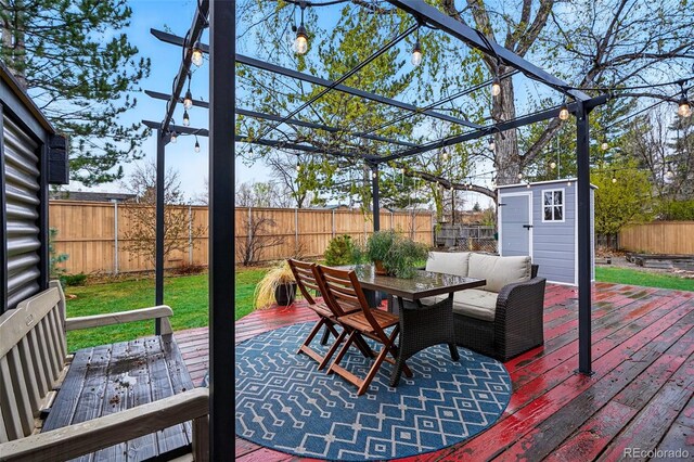3053 Mcintosh Dr, Longmont, CO 80503 - wooden deck featuring outdoor dining area, a shed, and a fenced backyard