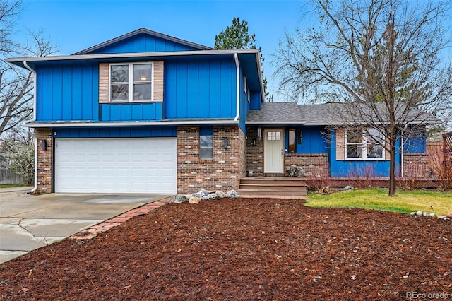 3053 Mcintosh Dr, Longmont, CO 80503 - view of front of house featuring board and batten siding, brick siding, driveway, and a garage