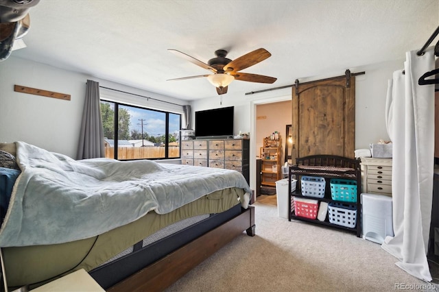 330 2nd St, Kersey, CO 80644 - bedroom with carpet flooring, ceiling fan, and a barn door