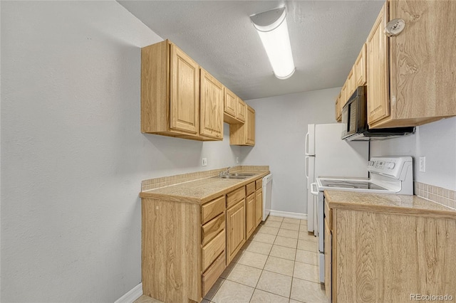 kitchen featuring a textured ceiling, light tile patterned floors, light brown cabinets, white appliances, and a sink