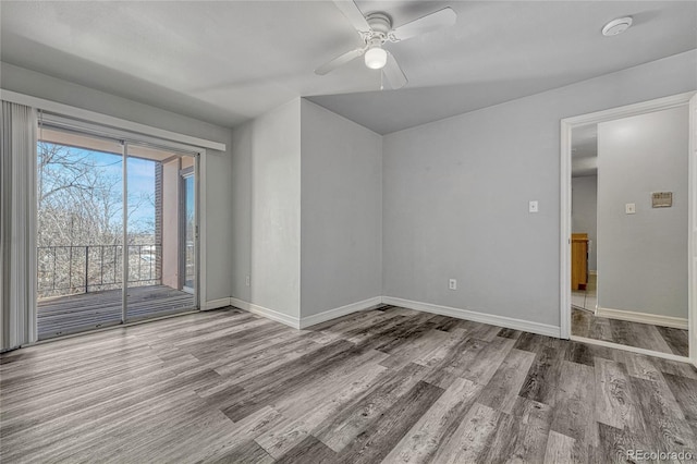 unfurnished room with ceiling fan, baseboards, and wood finished floors