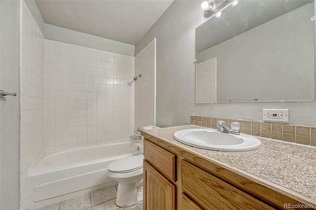 full bath featuring toilet, vanity, washtub / shower combination, and tile patterned floors