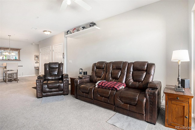 living room featuring carpet floors, ceiling fan, and baseboards