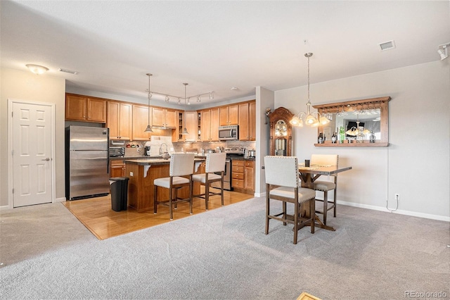 dining space with a chandelier, visible vents, light carpet, and baseboards