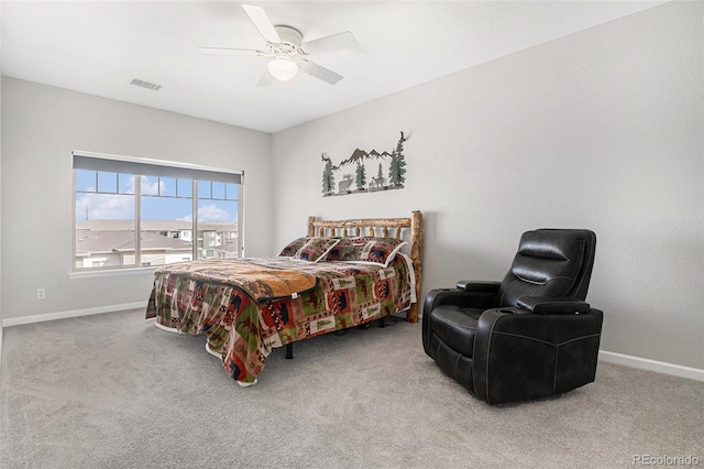 carpeted bedroom featuring a ceiling fan, visible vents, and baseboards