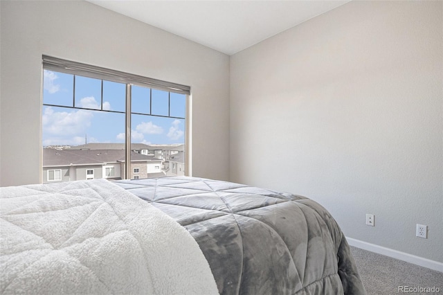 carpeted bedroom featuring baseboards