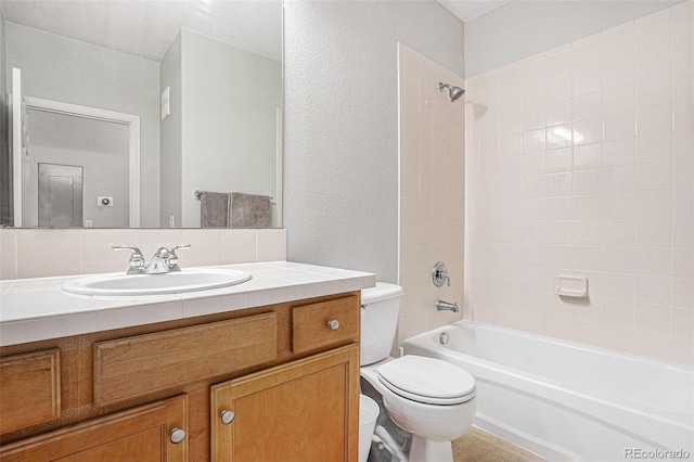 bathroom featuring bathtub / shower combination, vanity, and toilet