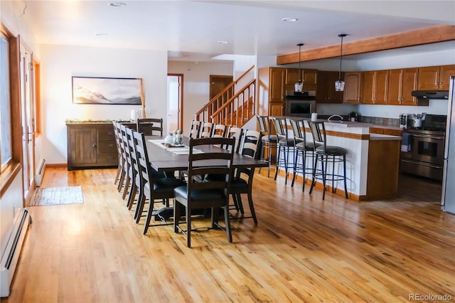 dining area with recessed lighting, stairway, baseboard heating, and light wood finished floors