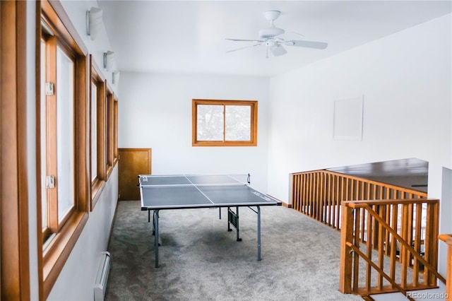 playroom with carpet floors, a ceiling fan, and a baseboard radiator