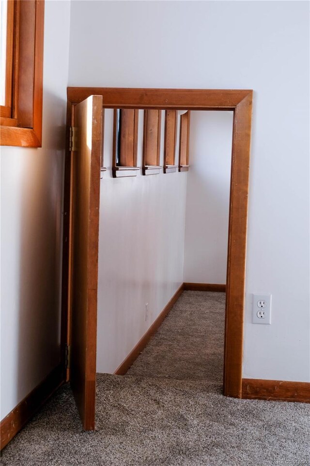 hall with carpet flooring and baseboards