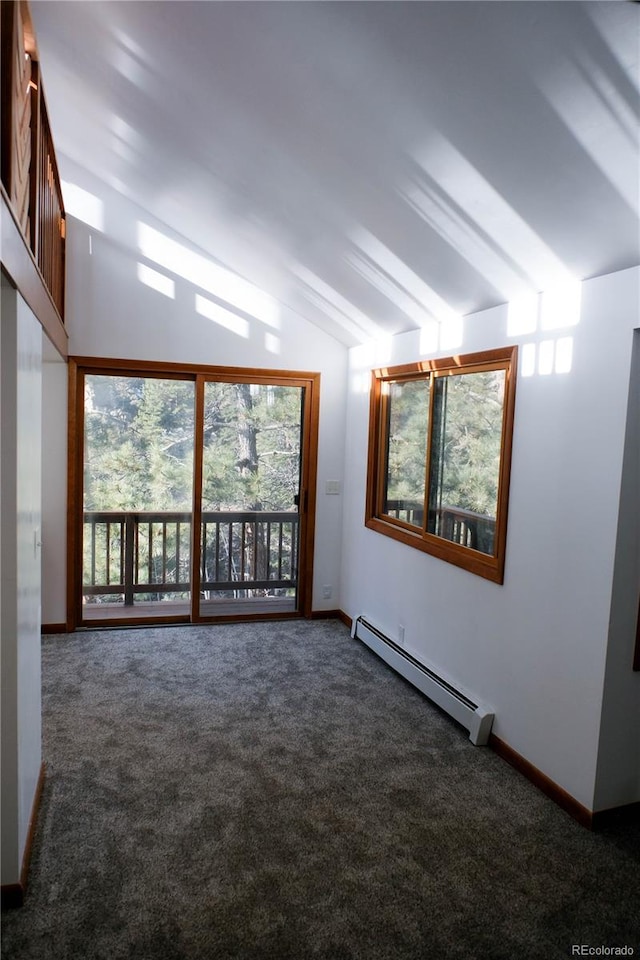 carpeted spare room with vaulted ceiling, baseboards, and a baseboard radiator