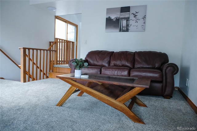 carpeted living area featuring baseboards