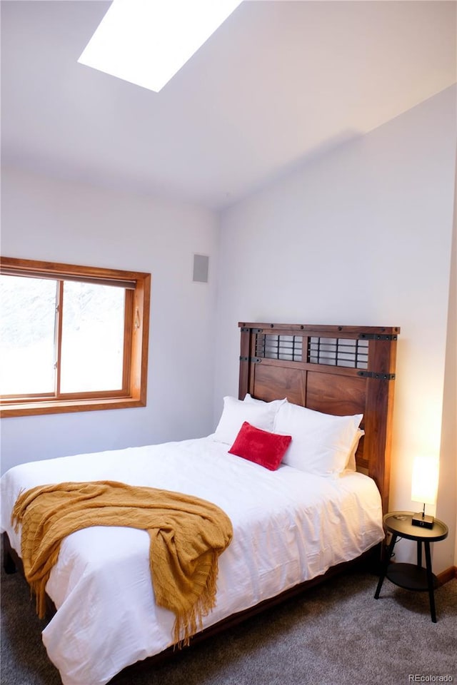 bedroom featuring carpet and a skylight