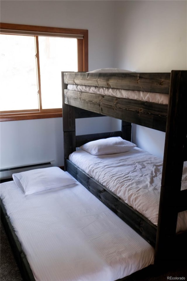 unfurnished bedroom featuring a baseboard radiator