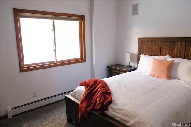 bedroom featuring baseboard heating and carpet flooring