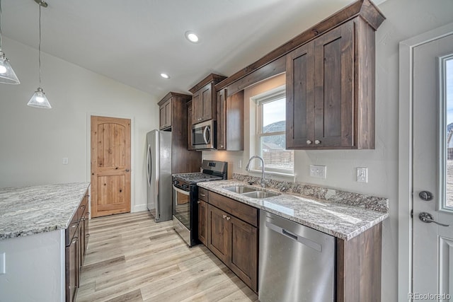 880 Hoover Cir, Poncha Springs, CO 81242 - kitchen with stainless steel appliances, lofted ceiling, a sink, light wood-style floors, and light stone counters