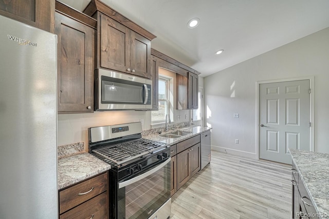 880 Hoover Cir, Poncha Springs, CO 81242 - kitchen with stainless steel appliances, baseboards, a sink, light wood-style floors, and light stone counters