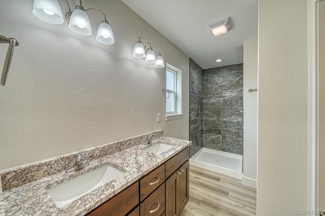 880 Hoover Cir, Poncha Springs, CO 81242 - bathroom with visible vents, wood finished floors, tiled shower, and a sink