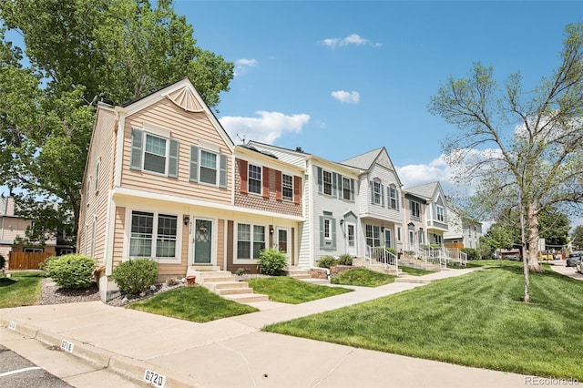 6722 S Independence St, Littleton, CO 80128 - townhome / multi-family property featuring a residential view, a front yard, and entry steps