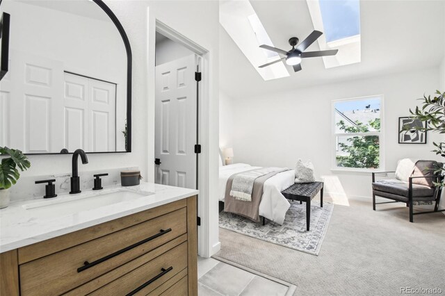 6722 S Independence St, Littleton, CO 80128 - bedroom with a sink, a skylight, lofted ceiling, light carpet, and a ceiling fan