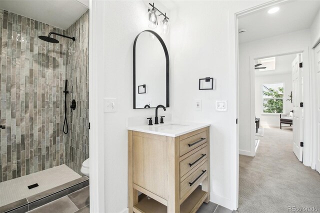 6722 S Independence St, Littleton, CO 80128 - full bath featuring tiled shower, vanity, toilet, baseboards, and recessed lighting