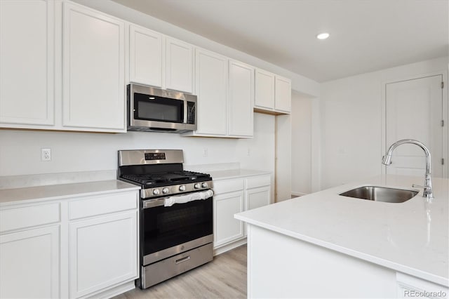 24780 E 39th Ave, Aurora, CO 80019 - kitchen featuring appliances with stainless steel finishes, a sink, white cabinets, light countertops, and recessed lighting