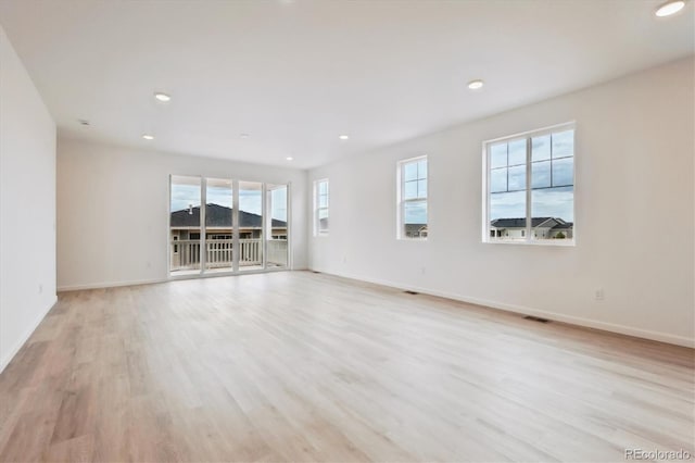24780 E 39th Ave, Aurora, CO 80019 - empty room featuring plenty of natural light, baseboards, light wood finished floors, and recessed lighting