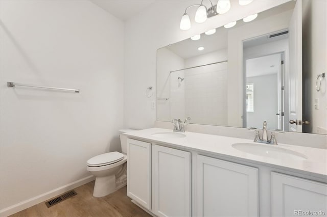 24780 E 39th Ave, Aurora, CO 80019 - full bathroom featuring toilet, wood finished floors, a shower, double vanity, and baseboards