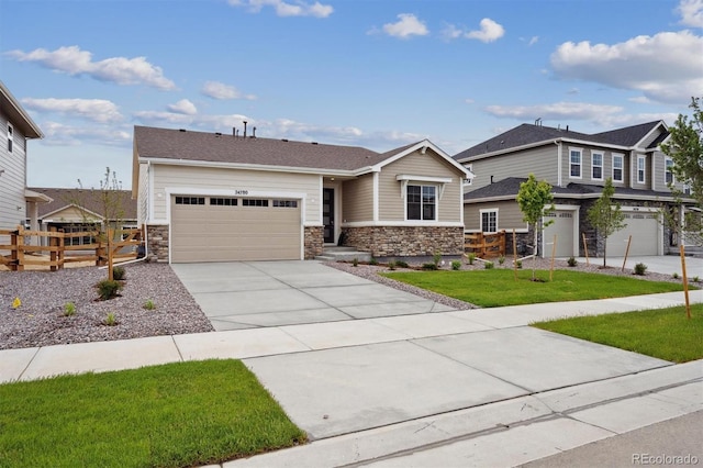 24780 E 39th Ave, Aurora, CO 80019 - view of front facade featuring stone siding, concrete driveway, and an attached garage