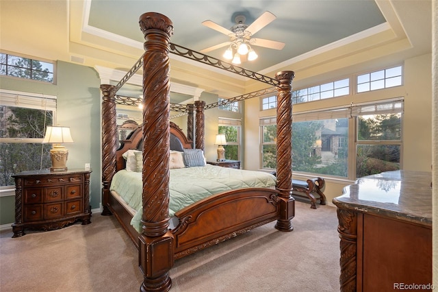 bedroom with carpet floors, crown molding, ceiling fan, and a raised ceiling